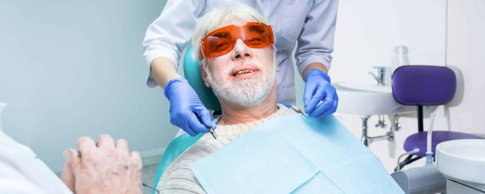Dentist with elderly patient
