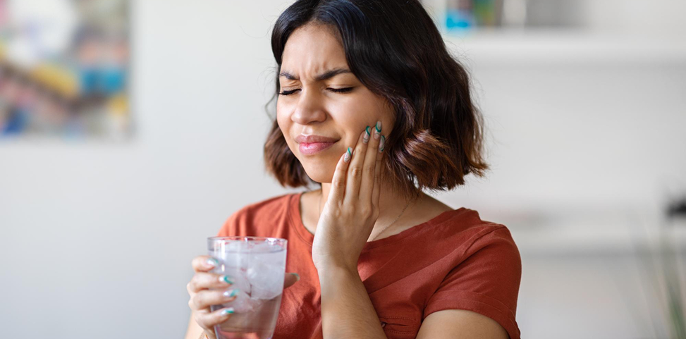 Dental Fillings Service at Oral Square Dental Care Person experiencing tooth sensitivity while drinking a cold beverage in Tarneit